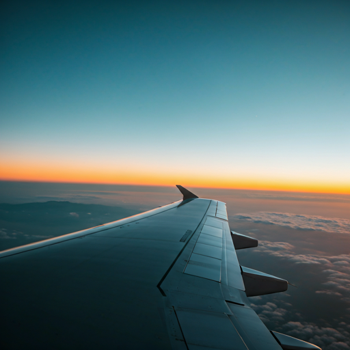 Airplane wing view at sunset