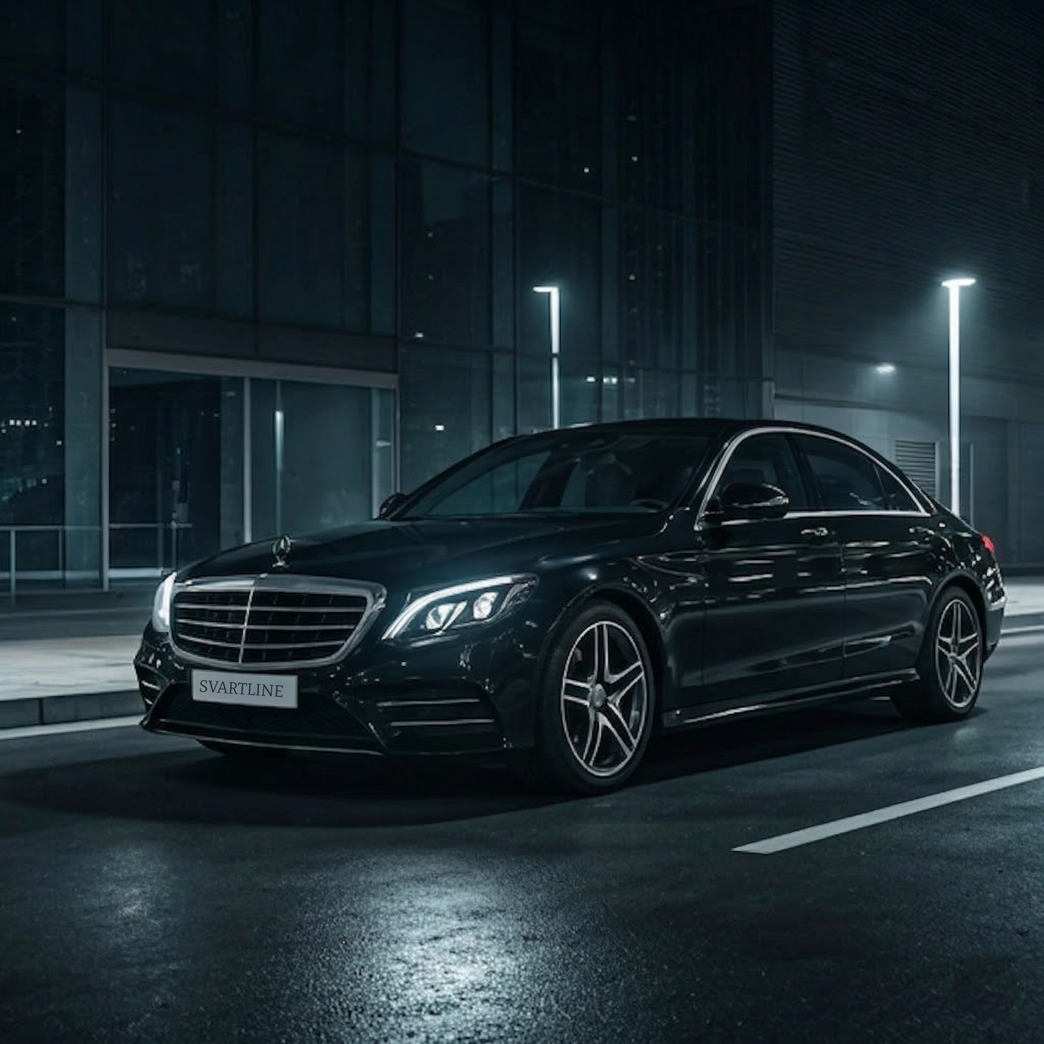 Luxury black Mercedes sedan in urban setting at night
